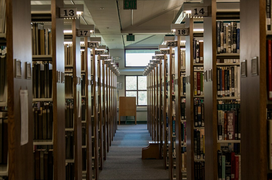 writer at desk with books